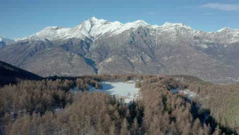 drone-flying-above-the-mountains-during-winter,-forward-movement