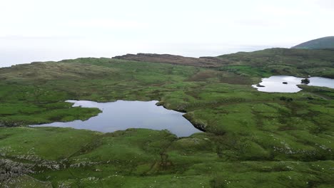 Aerial-panorama-view-of-beautiful-cliffs-of-Fair-Head-cliffs-in-Northern-Ireland-overlooking-the-pristine-nature-and-unique-destination-for-an-adventure-for-hikers-and-climbers