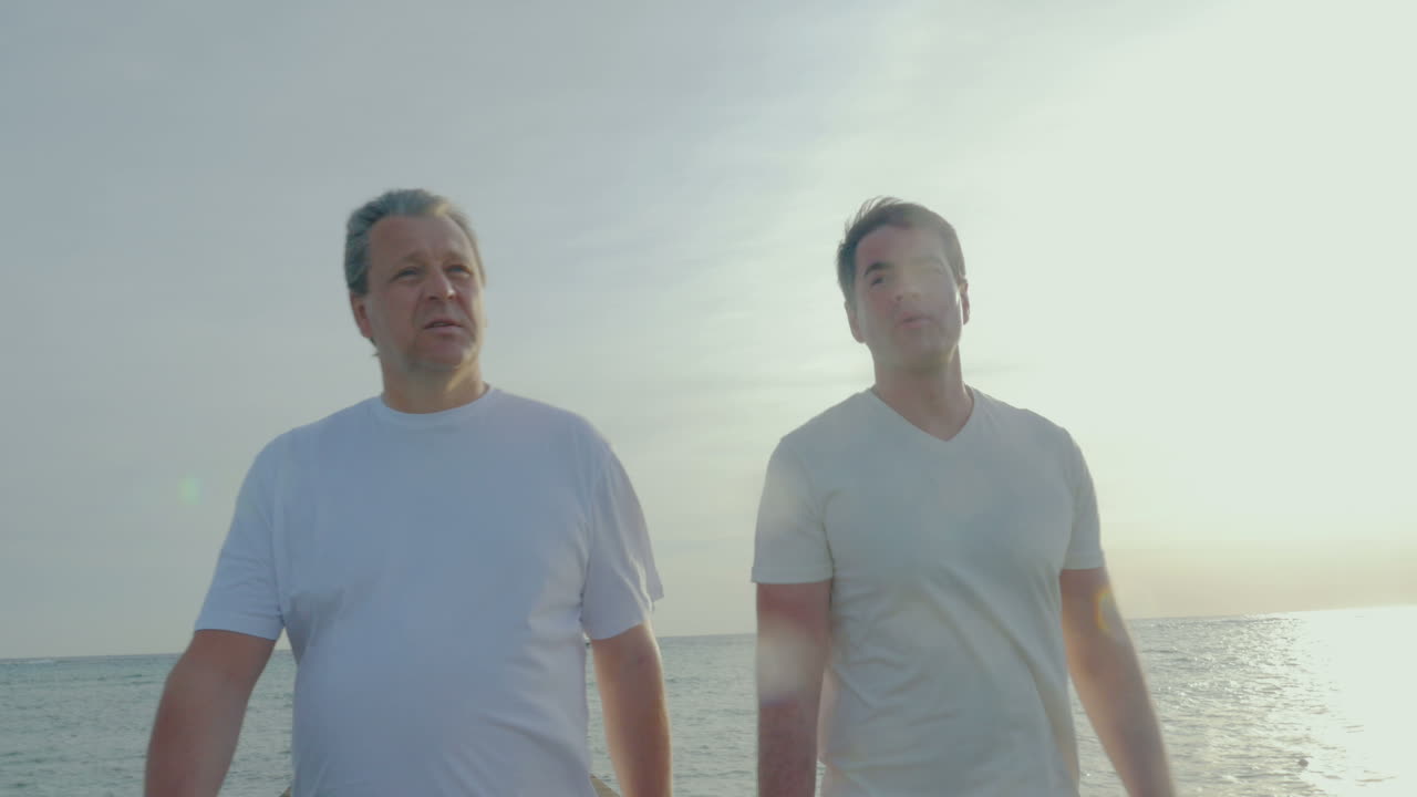 아버지 와 아들 이 아침 운동 을 하고 나서 산책 하고 있다