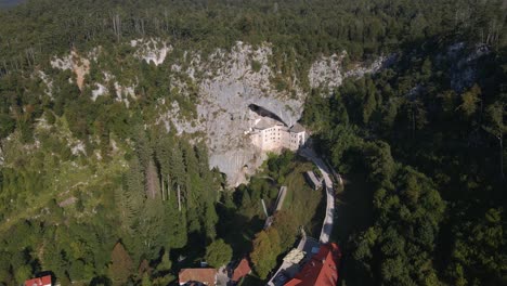 drone shot over predjama near predjama castle, connected to postojna cave