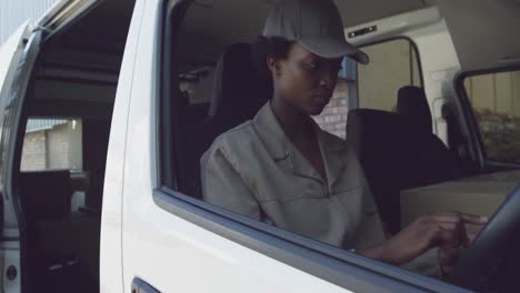 young female van driver with a warehouse delivery