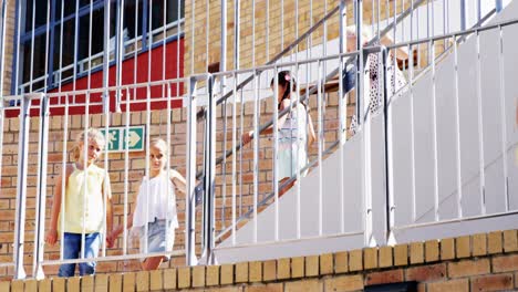 group of kids getting down from staircase