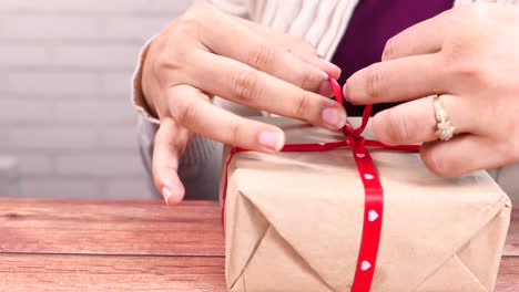 hands wrapping a gift