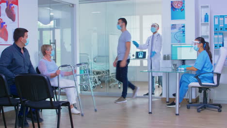 nurse talking with invalid woman in hospital reception