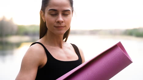 woman with mat in the forest