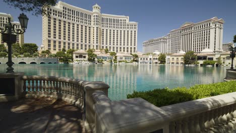 a jib up reveal of the bellagio fountains, which are no longer running during the covid-19 pandemic on the las vegas strip. the sidewalk is empty.