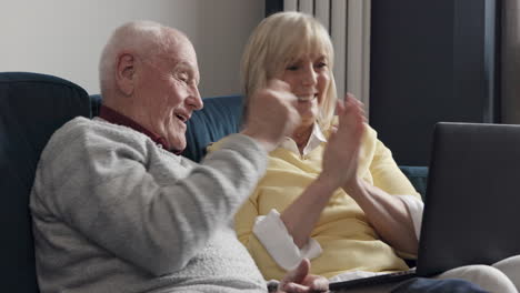 elderly couple using laptop for video call