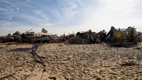 Camera-reveals-abandoned-and-destroyed-refugee-camp-shelter-at-Gaza-beach-during-Israel–Hamas-war-conflict,-2024