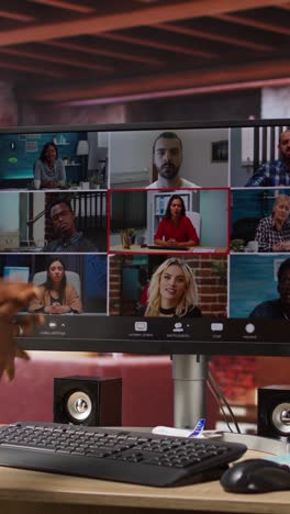 vertical video employee greeting coworkers during videocall from home desk