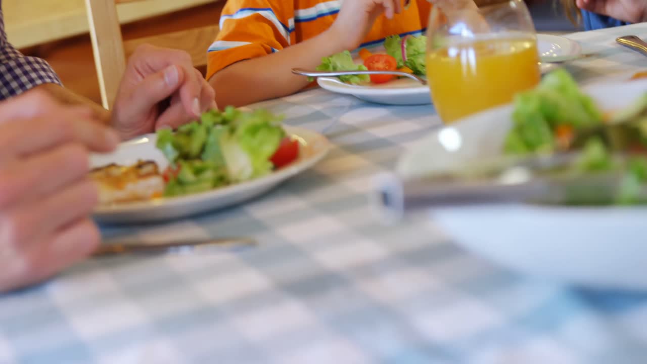 Father and son having meal in restaurant 4k