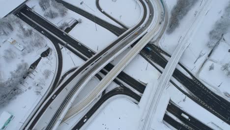 Vista-Aérea-De-Una-Intersección-De-Autopistas-Cubierta-De-Nieve-En-Invierno.