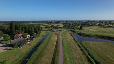 pumping station part of water management in dutch river valley landscape at the end of meandering embankment with in the distance the ruins remains of nijenbeek