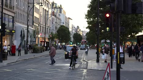 pedestrians and vehicles at a busy intersection