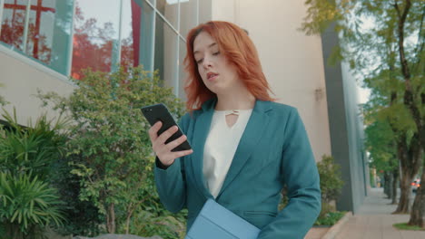 Shot-of-a-caucasian-businesswoman-checking-email-on-phone