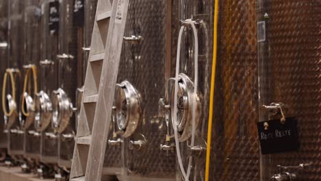 stainless steel wine tanks in cellar of winery ready for the harvest