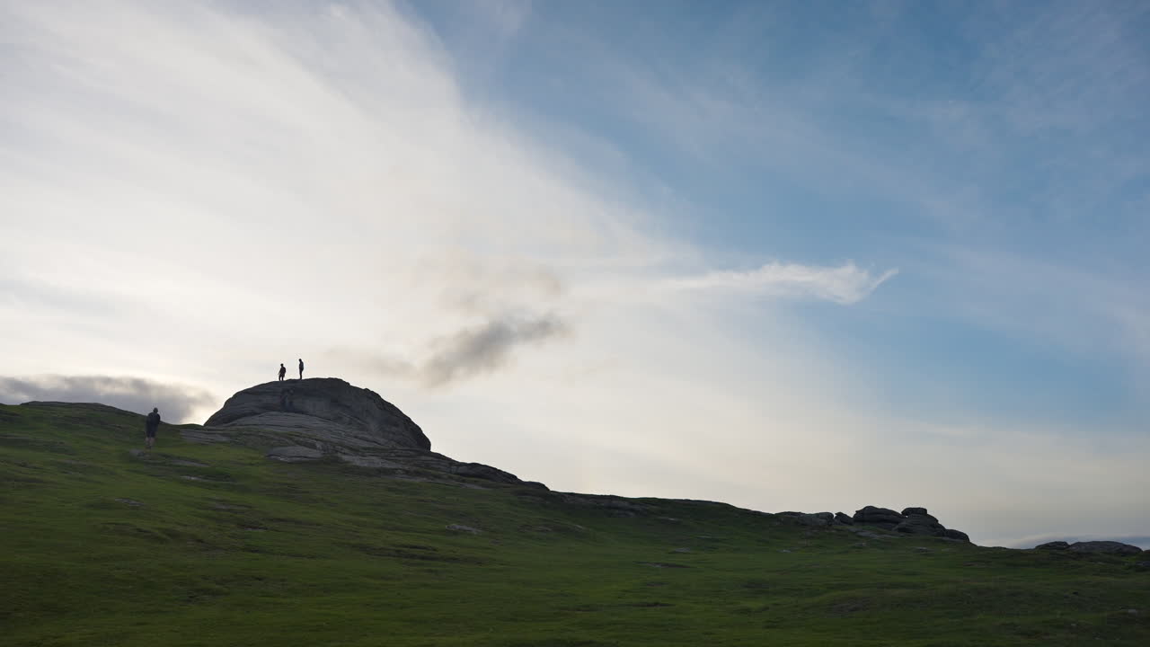 People on a Mountain Top at Sunset