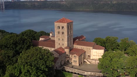 clockwise aerial orbit of the cloisters museum in crispy morning sunshine on the bank of the hudson river in nyc