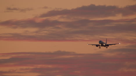 airplane landing at sunset