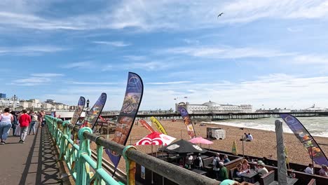 people walking along brighton beach promenade