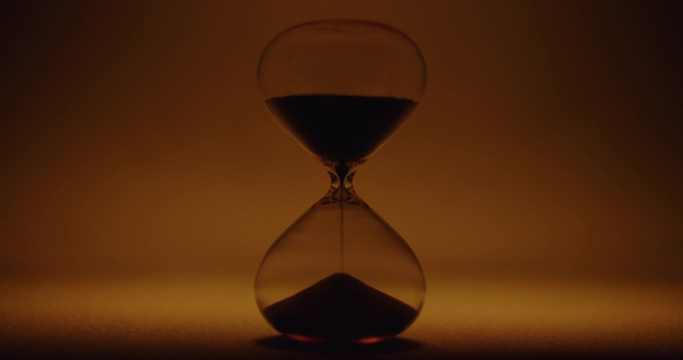 Hour glass on orange colored background