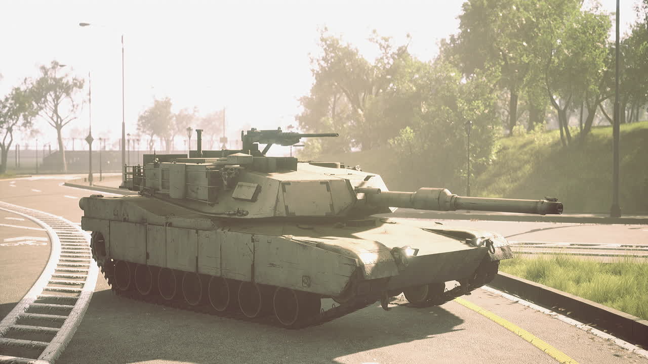 Military tank parked on urban road in bright sunlight during daytime