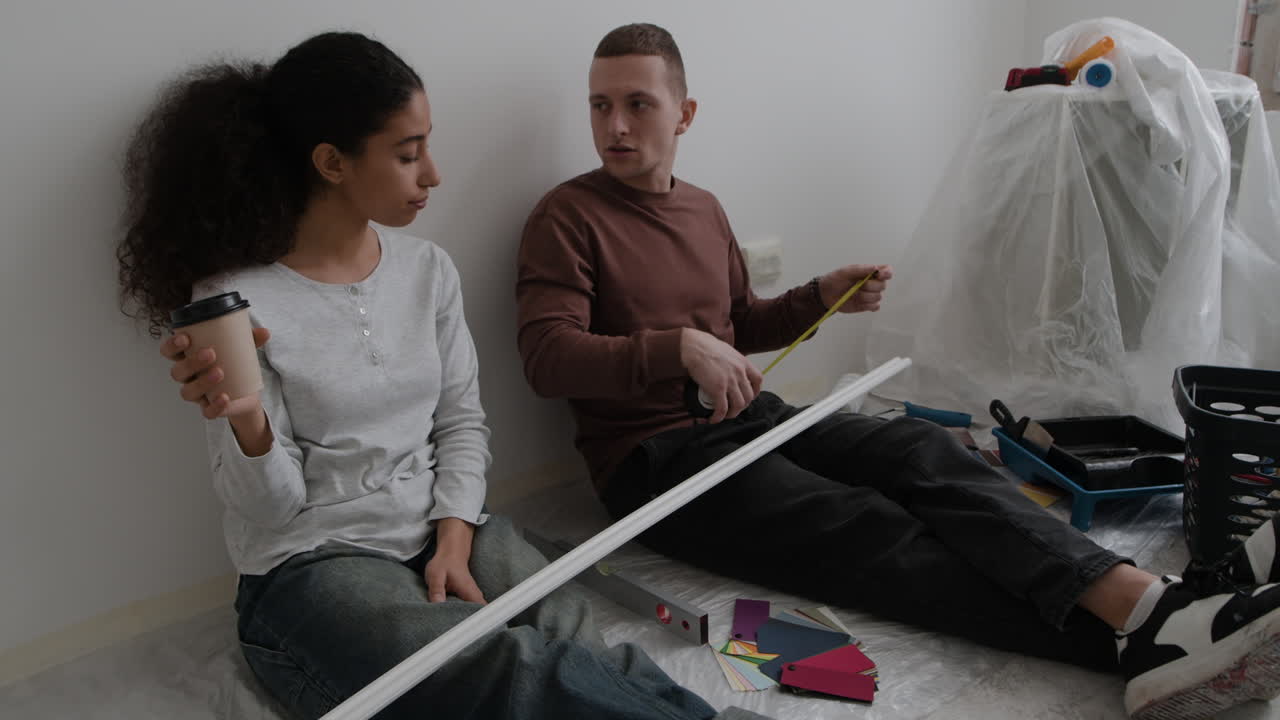 Young Couple Planning Home Renovation Project