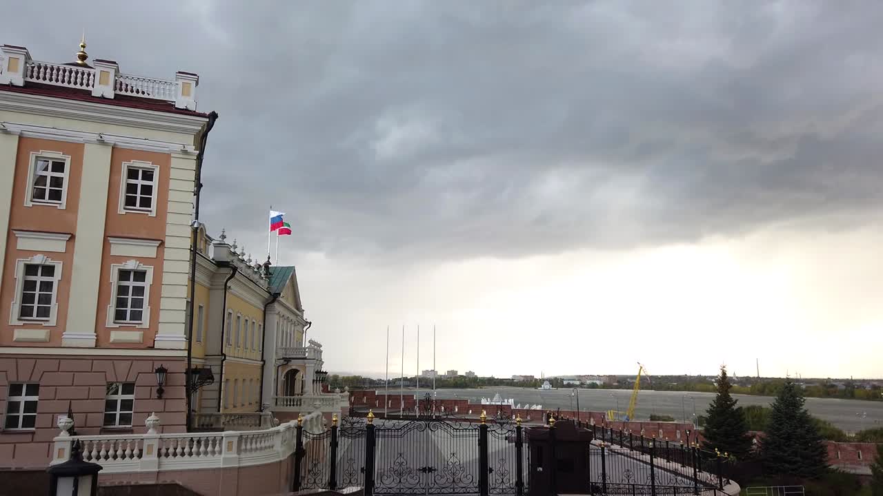 Random buldings in Kazan, Kremlin with the flag of Russia and riverside in front. Camera pan shot.