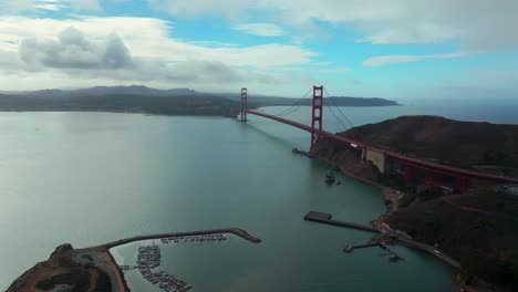san francisco golden gate bridge aerial drone california point cavallo needles rock horseshoe bay area dana bowers vista point cloudy mist misty fog blue skies sausalito cars traffic forward pan up
