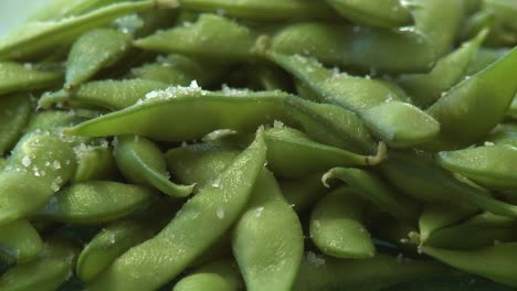 close up pan of salted organic soy bean pods