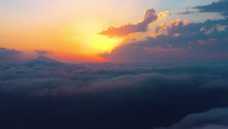 flying over the clouds with the late sun. sunrise or sunset colorful sky background.