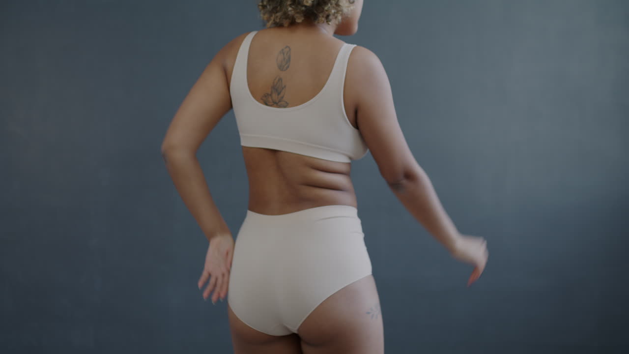 Woman in Undergarments with Back Tattoo