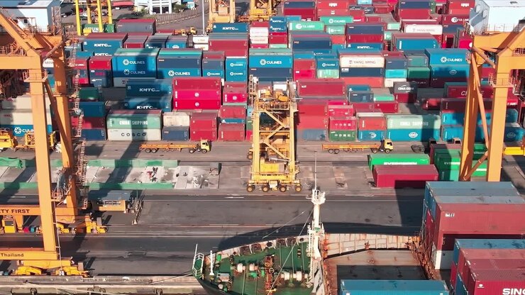 Busy shipping port in Bangkok with cranes and cargo containers