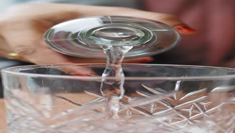 pouring water into a glass