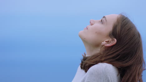 portrait of happy woman looking up smiling enjoying freedom outdoors exploring wanderlust contemplating spiritual journey in countryside breathing fresh air feeling positive