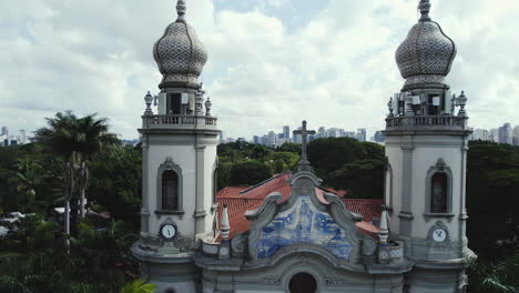 aerial view flying low over the igreja nossa senhora do brasil, in cloudy sao paulo