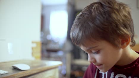 Close-up-shot-of-caucasian-boy,-doing-distance-education-in-front-of-the-computer,-pan-4K