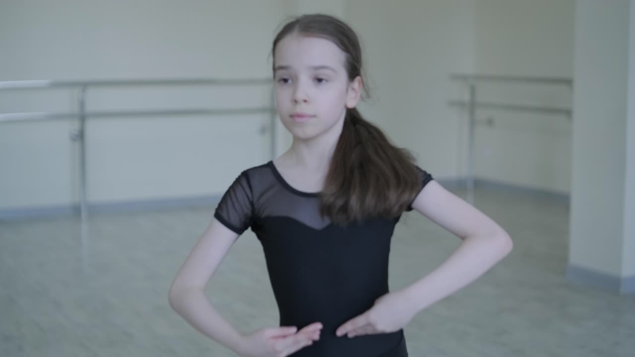 Young Ballerina Practicing Dance Moves in Studio