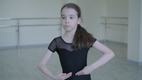 young ballerina practicing dance moves in studio