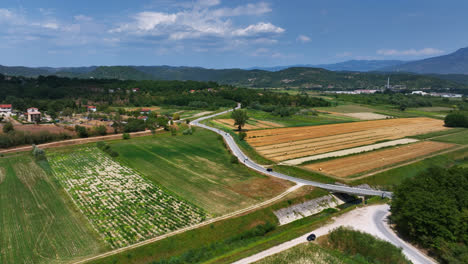 scenic aerial view of countryside with fields, road, and hills