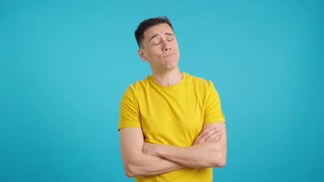 man in yellow shirt on blue background