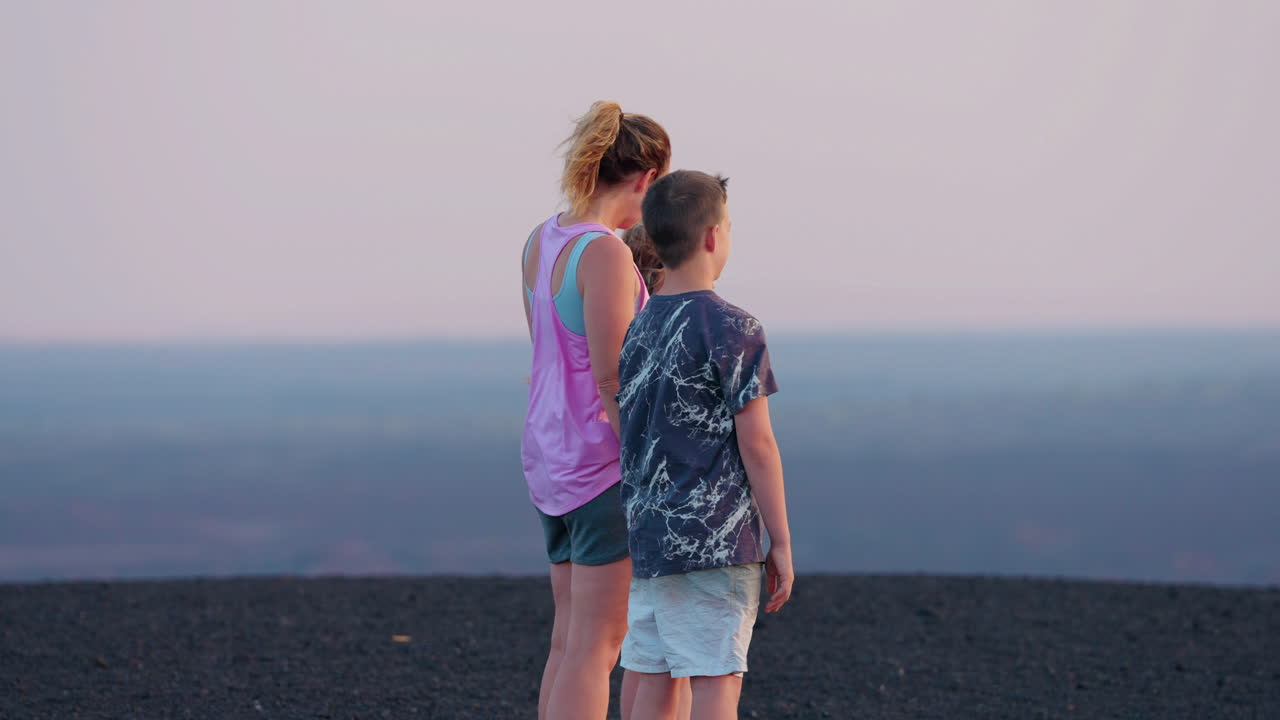 Family enjoying a scenic overlook at dusk or dawn