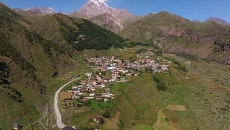 aerial pan up reveals gergeti, georgia