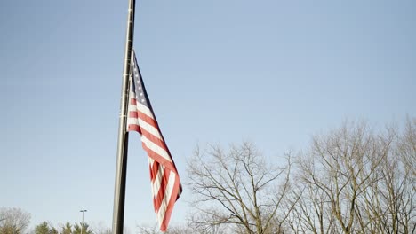 american flag floating in the wind on an autumn day