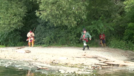 Men-come-out-of-the-woods-to-fight-a-battle-in-this-television-style-reenactment-of-the-War-of-1812