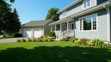 a modern suburban house with a green lawn and colorful garden