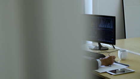 mature male stock market expert working with the computer