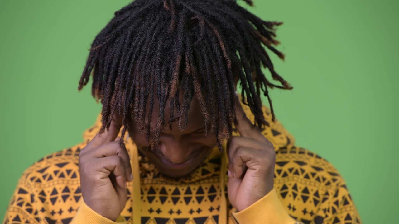 Young handsome African man having headache