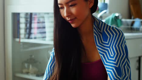 Beautiful-woman-having-coffee-while-using-digital-tablet