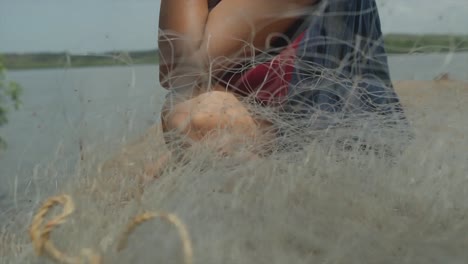 in a natural environment, a sensual woman's face reflects concern as she contemplates discarded fishing nets, highlighting the pressing issue of environmental problems