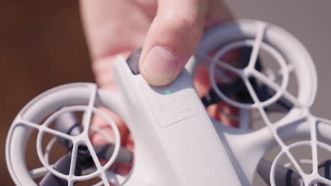 close-up of a person holding a small white drone